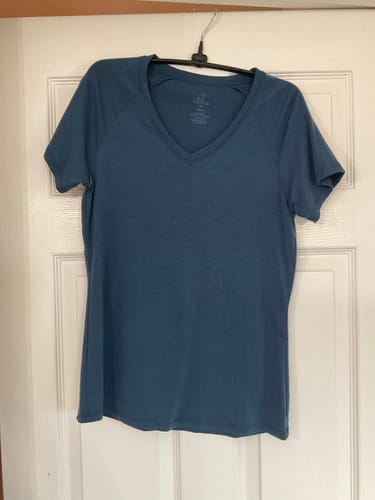 Customer's Mia V Neck t-shirt in the rich Starry Night color shown on a hanger.
