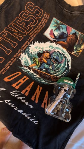 Customer's Lilo & Stitch Ohana Forever vintage wash tee laid flat, showcasing the colorful surfing graphic.
