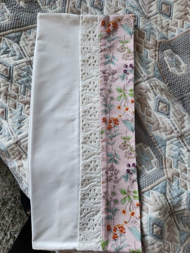 Reviewer's project showing white fabric, intricate white lace, and a floral patterned fabric sewn together using the Singer 9960.