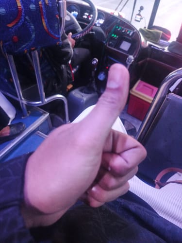 Reviewer giving a thumbs-up gesture, indicating satisfaction with their purchase.