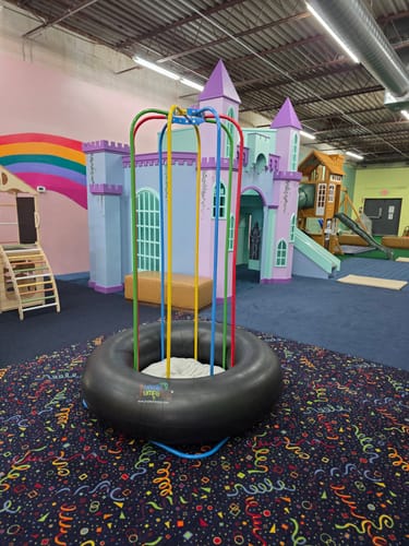 Customer's Jungle Jumparoo with colorful vertical bars set up inside a children's play place.
