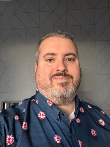 Customer showing a close-up of the detailed parachute pattern on their blue NASA 'Dare Mighty Things' shirt.