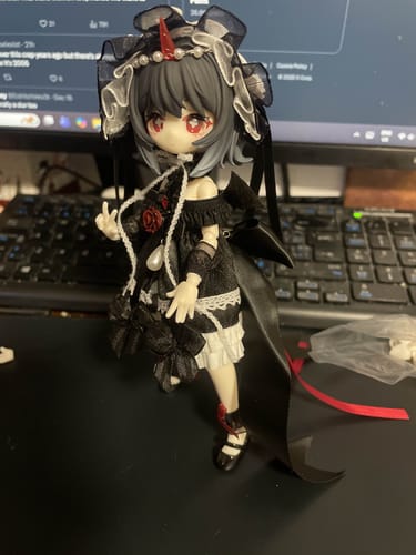 Customer's Meki Rose Special Color action figure posed on a desk, wearing a detailed black and white dress with a red horn.