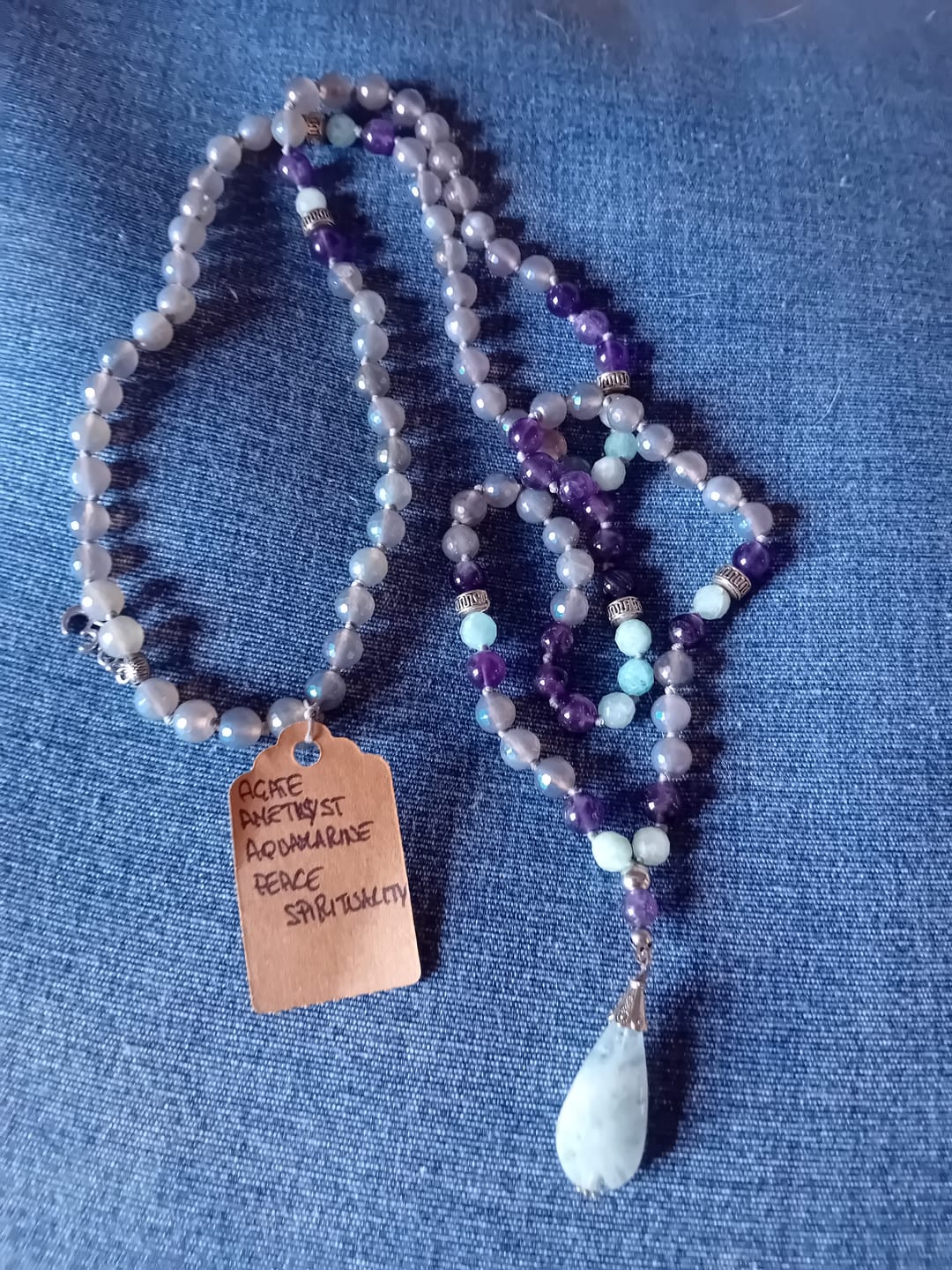 Customer photo review of Spiritual Mala in Gray Agate, Amethyst and Aquamarine | 108 Beads | OM Charm + Aquamarine Pendant