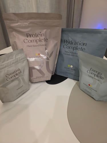 Reviewer's Wonder Woman Bundle, showing pouches of Protein, Hydration, Creatine, and Energy Complete on a table.