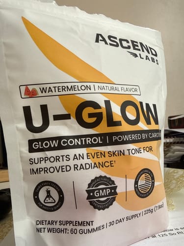 Customer's white pouch of U-GLOW watermelon-flavored gummies, a dietary supplement for improved radiance.