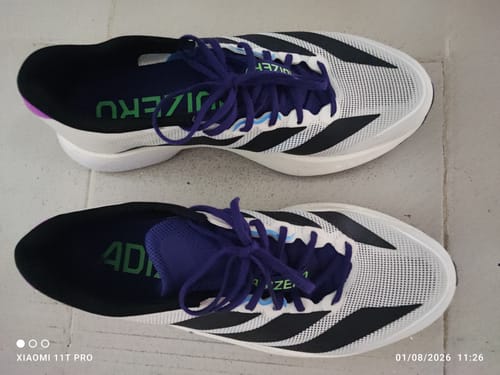 Customer's pair of adidas Adizero Boston 13 running shoes in white with black stripes and purple laces, viewed from above.