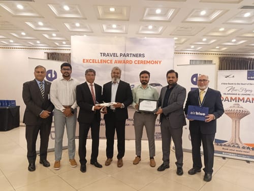 Customer photo showing a group of people posing with an award at a ceremony, unrelated to the military baton.