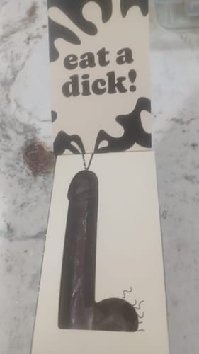 Customer's 'Eat a Dick' chocolate penis gag gift shown in its open packaging, displaying the novelty item.