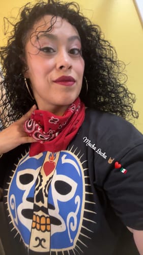 Reviewer posing in the black Viva La Lucha tee, showing the large luchador mask graphic.