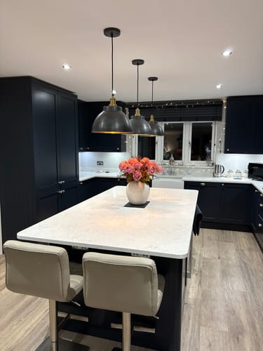 Customer's beige Zoe Ceramic Vase styled with lovely roses on a kitchen island.