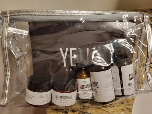 Customer's Awakening Complete 5-Piece Trial Kit shown inside its clear travel bag on a counter.