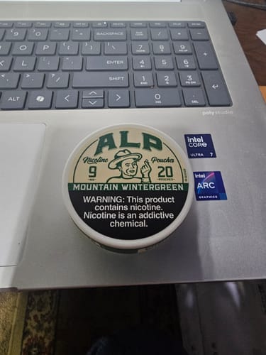 Customer's can of ALP Mountain Wintergreen Nicotine Pouches sitting on a laptop.