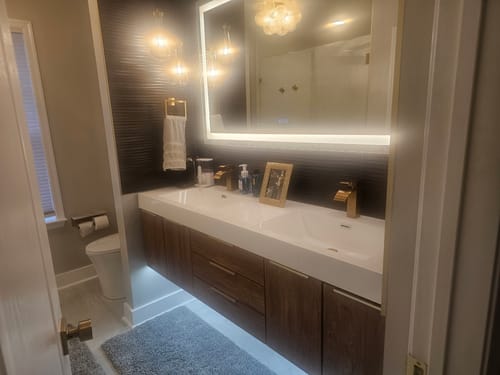 Customer's installed Breton Floating Vanity with a wood cabinet and double sink in a modern, remodeled bathroom.