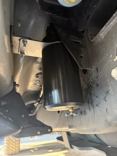 Customer's view of the installed SPE Motorsport CCV Catch Can, showing the black canister mounted to the truck frame.