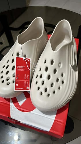 Customer's new off-white Nike ReactX Rejuven8 shoes resting on the shoebox.