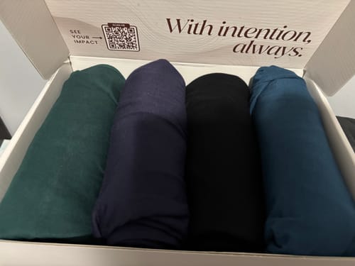 Customer's Peacock maxi jersey hijab rolled in an open box with three other hijabs.