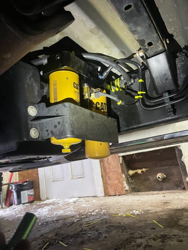 Customer's SPE Motorsport Fuel Filter System with two yellow filters installed cleanly underneath a truck.
