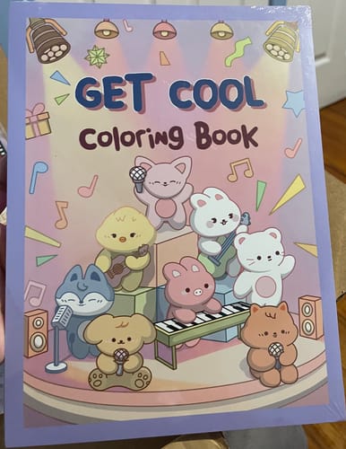 Customer holds the sealed SKZOO COLORING BOOK, showing the colorful illustrated front cover.