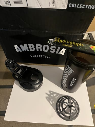 Customer's new black Ambrosia Collective Sport Shaker disassembled next to its box with a Hydroglyph packet in the cup.
