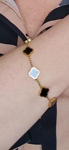 Customer wearing the Celine Clover Bracelet on their wrist, showing the black and white clover charms.
