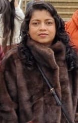 Reviewer wearing the soft coffee-colored Faux Fur Jacket with a funnel neck.