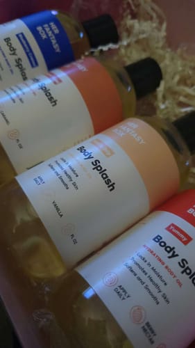 Customer's angled photo of the Sweet Skin Body Oil Bundle, showing the four oils arranged in a box.