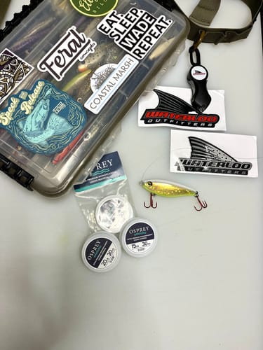 Reviewer's three compact spools of Osprey leader material shown with a tackle box and lure.