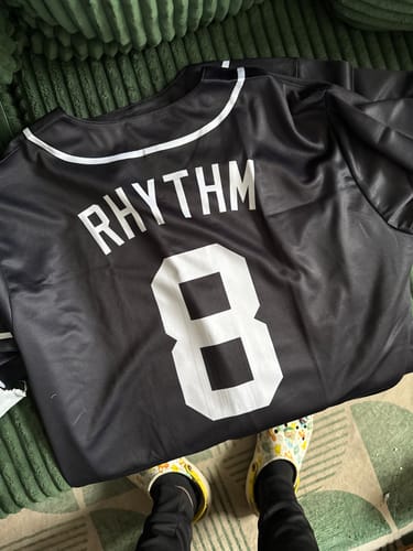 Customer's custom black baseball jersey showing the name "RHYTHM" and number "8" on the back.
