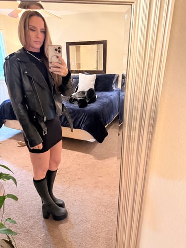 Reviewer styling the Naked Mock Neck Mini Dress with a black jacket and boots.