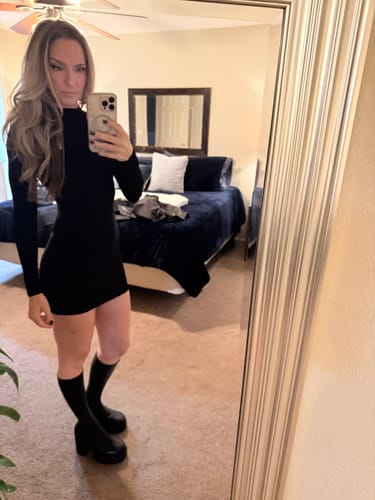 Reviewer taking a mirror selfie in the black long-sleeve Naked Mock Neck Mini Dress.