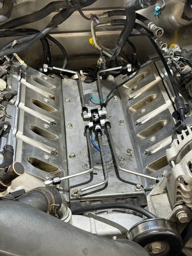 Reviewer's LS Stainless Coolant Crossover Kit installed on an engine, highlighting its clean fit and stainless steel lines.