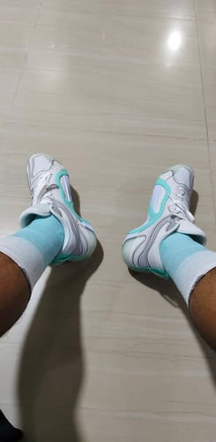 Customer's top-down view of their new white and mint green Jordan Jayson Tatum 3 PF shoes worn indoors.