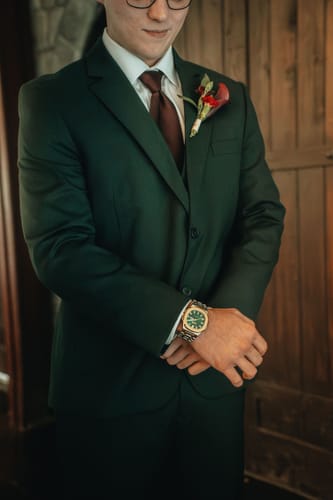 Customer wearing the Lucky Fours® Brone watch with a dark green suit for their wedding.