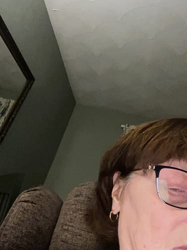 Close-up: Reviewer wearing a small gold Hoop Earring.