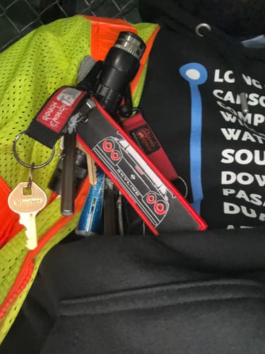 Customer's embroidered SKYLINE JET TAG on a keyring with other keys and a flashlight.