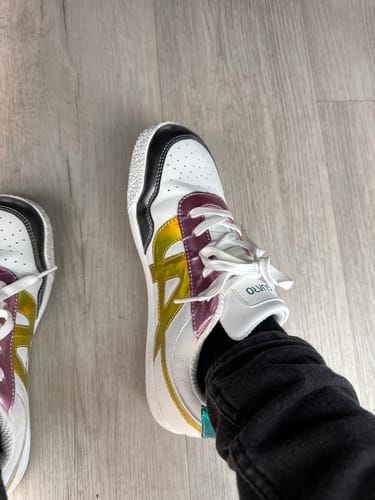 A customer's top-down view of the Dash I - Barefoot Shoes, which are white with colorful metallic and black accents.