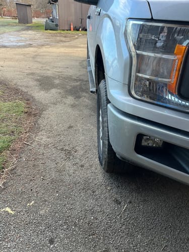 Customer's F150 front wheel before installing wheel spacers, showing the wheel tucked inside the fender.