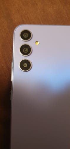 Close-up of the customer's light purple Samsung Galaxy A34, showing the triple camera system.
