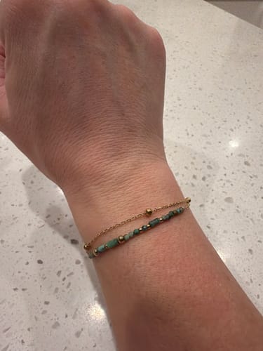 Customer wearing the dainty, two-strand Layered Stone Beads Bracelet on their wrist.