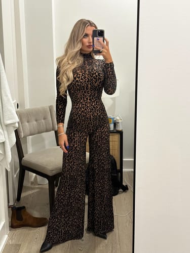 Customer posing in a mirror wearing the leopard print Burnout Wide-Leg Jumpsuit.