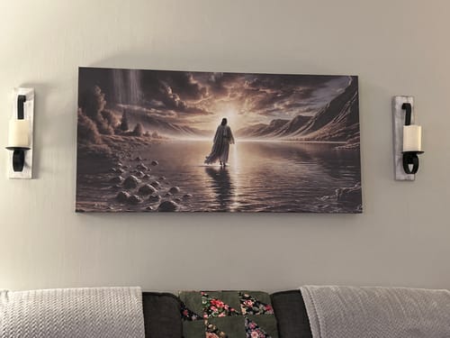 Customer's 'Walking on Water' canvas hung above a sofa, showing Jesus walking toward a bright light.