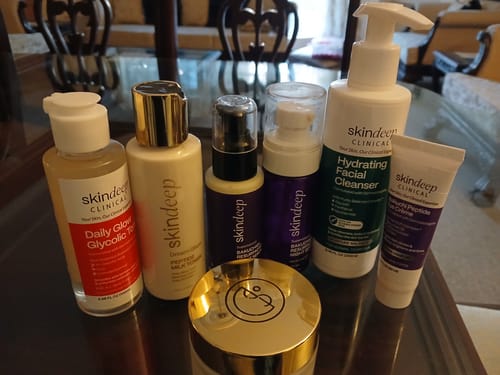Customer's Bakuchiol Resurfacing Night Serum shown with a collection of other skincare products on a table.