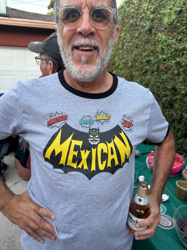Customer smiling while wearing the grey El Gringon OG Old School T-Shirt with its 'Mexican' graphic.