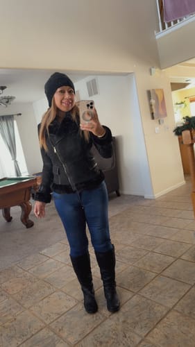 Customer taking a full-length mirror selfie wearing the Blaer Black Suede Faux Fur Moto Jacket.