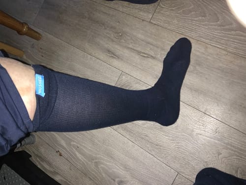 Customer showing the fit of a dark Performance Eucalyptus Compression Sock on their leg.