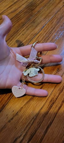 Customer holding the Cinnamoroll Pendant Keychain, showing the Cinnamoroll and pink heart charms.