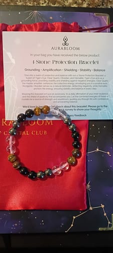 Reviewer's 4 Stone Protection Bracelet from the VIP Crystal Club, shown with its red pouch and description card.