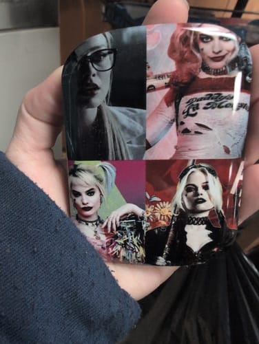 Customer holding their personalized ChargePod shell featuring a glossy, four-panel collage of the character Harley Quinn.