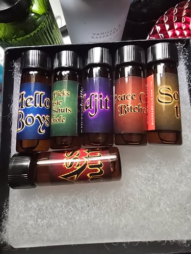 Reviewer's Wayward AF Collection, showing six small perfume oil bottles with colorful labels in a box.